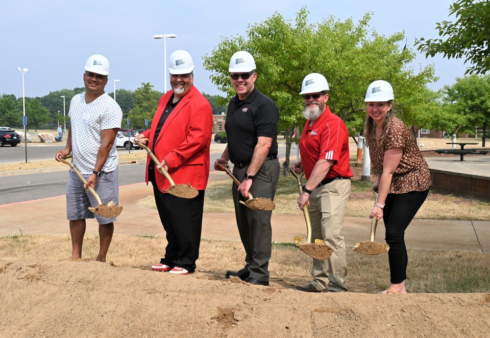 school board members with shovels and hardhats at construction groundbreaking