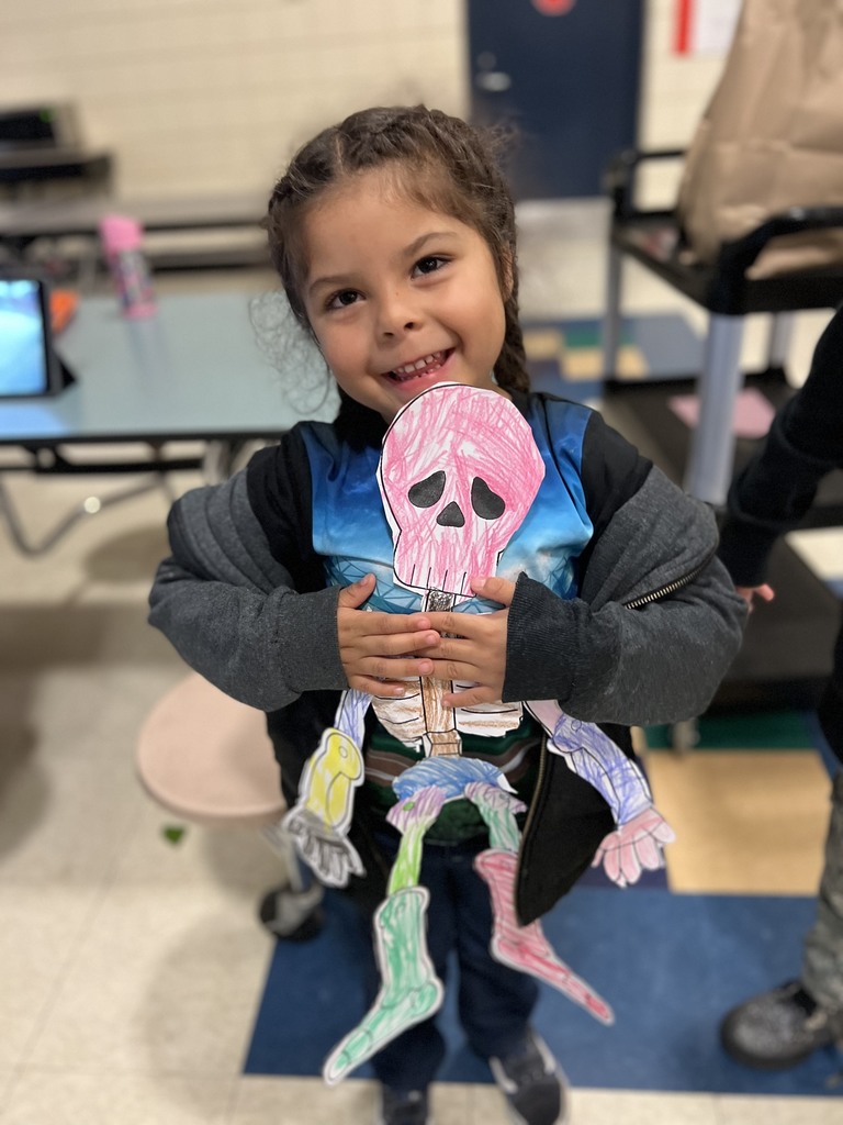 Child holding a stuffed animal at the Later Elementary.