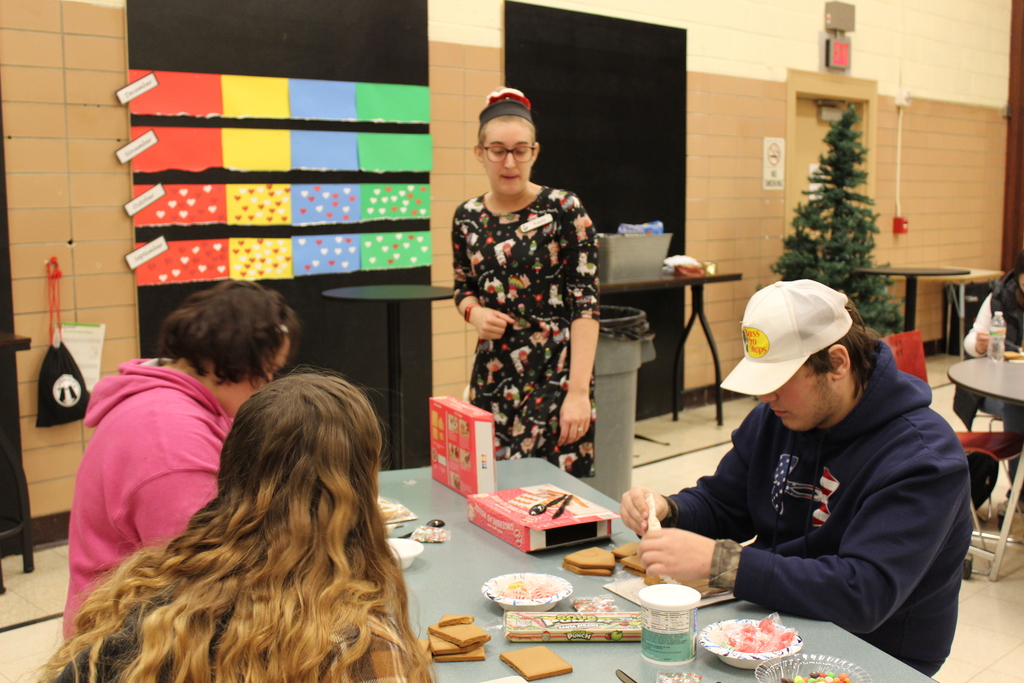 Ms. Kayla gives students directions for gingerbread houses