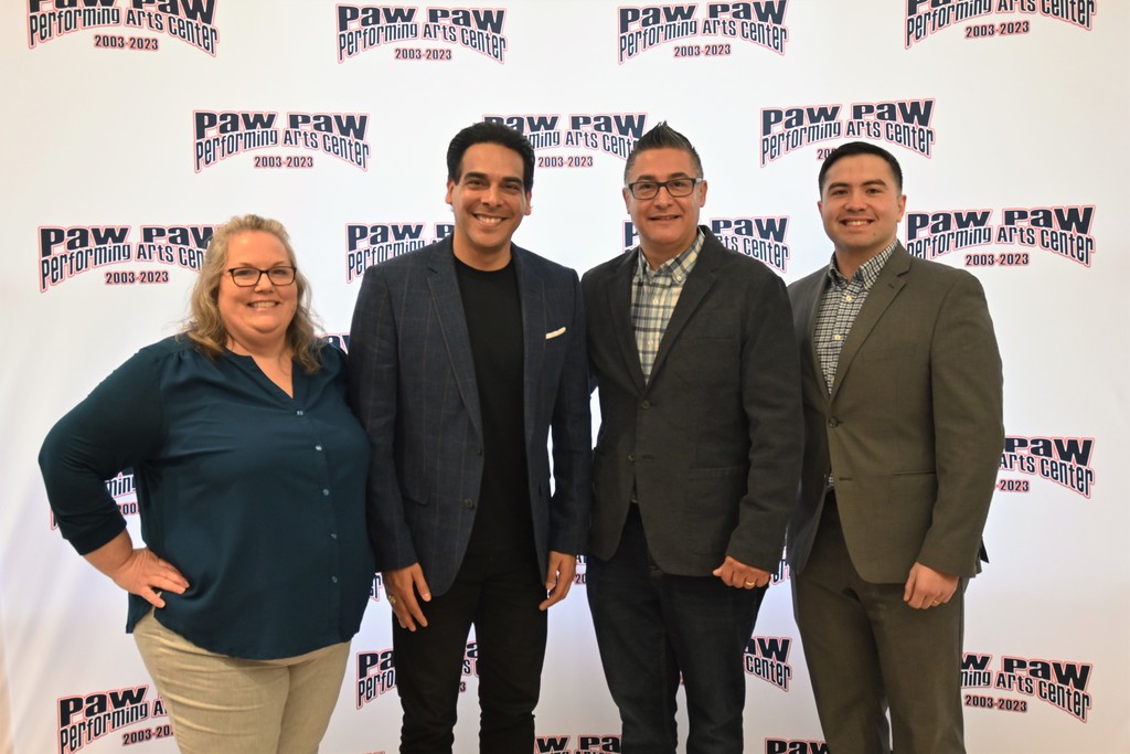 4 people in front of backdrop