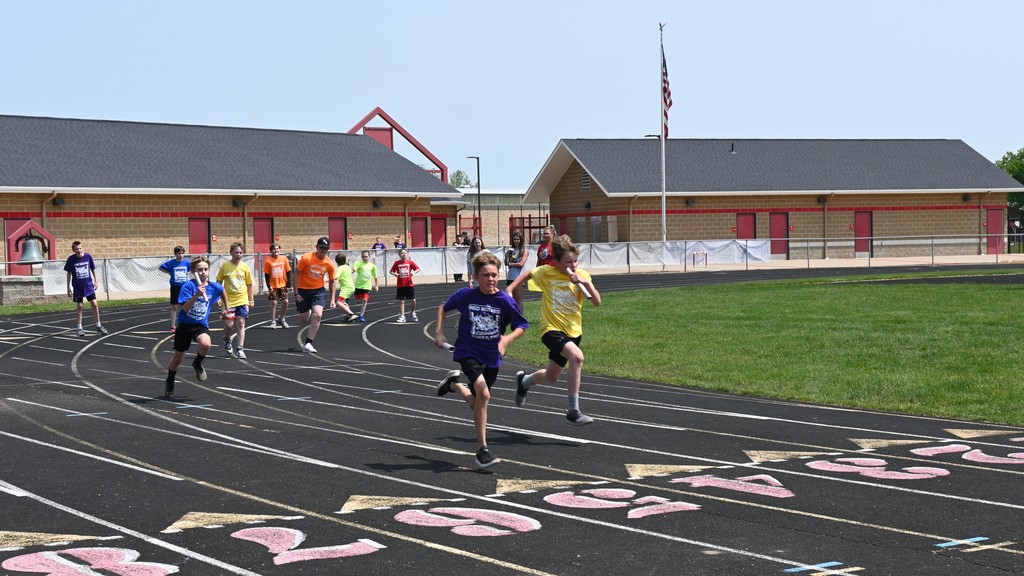 students running relay race at Falan Field