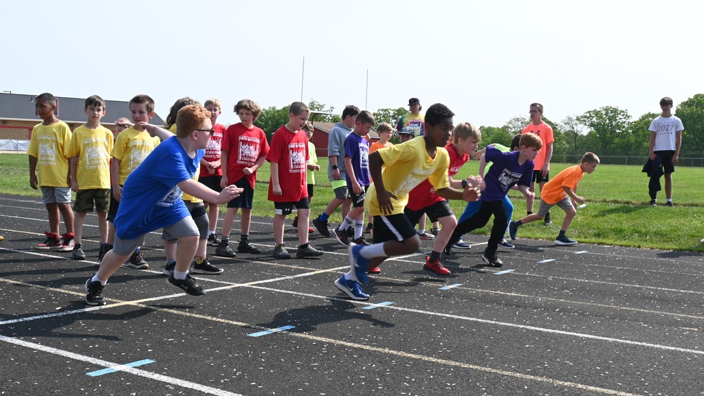 5th grade students running relay race at Falan Field