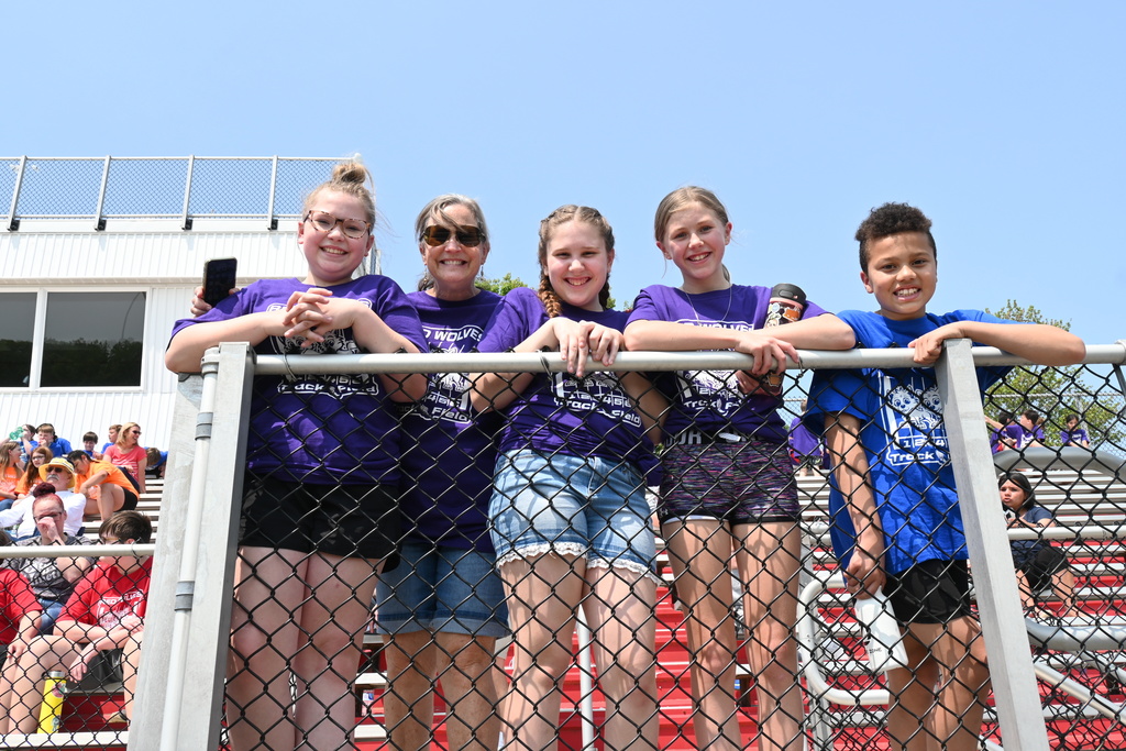 5 students in stands at Falan Field