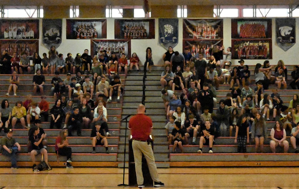 principal speaking to students in gym