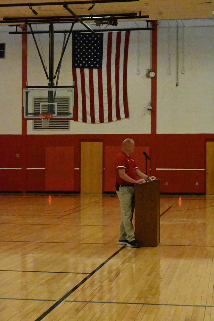 principal speaking in gym to students