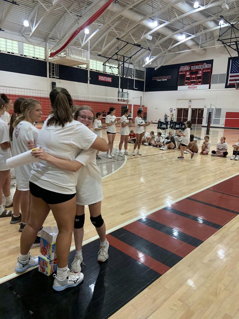 volleyball players embracing in gym